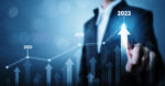 Businessman pointing arrow graph corporate future growth plan. Business development to success and growing growth year 2022 to 2023 concept